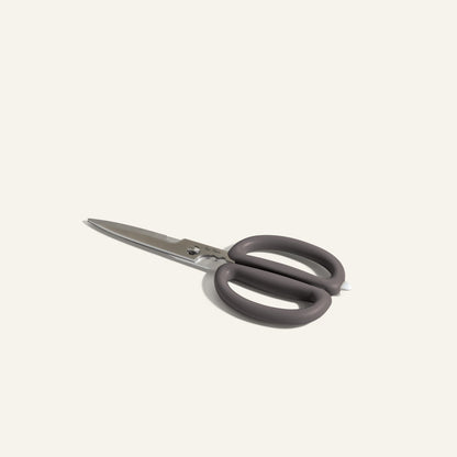 Shear Genius stainless steel kitchen shears with black ergonomic handles and a multifunctional design, displayed on a plain light background.