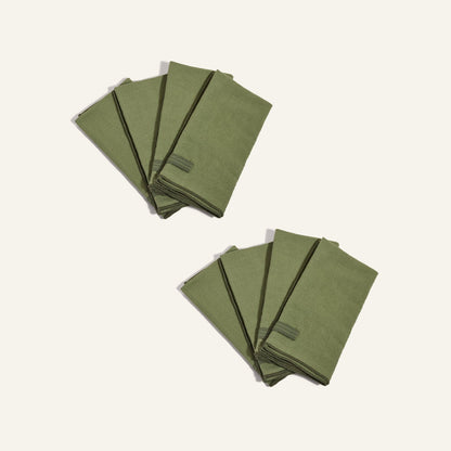 Two sets of four Loop Napkins, neatly folded, are arranged on a plain light background.