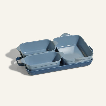 The Bakeware Set features four blue rectangular baking dishes in different sizes, stacked neatly on a light background—an elegant and stylish addition to any kitchen.
